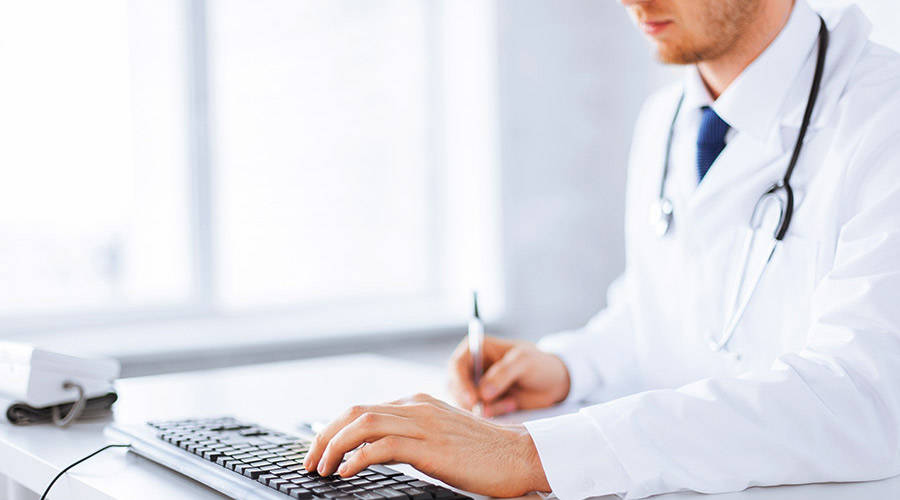 physician-entering-data_2 Physician Entering Data for Medical Record