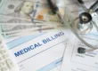 Medical Billing strategy concept with stethoscope on top of hundred dollar bills.