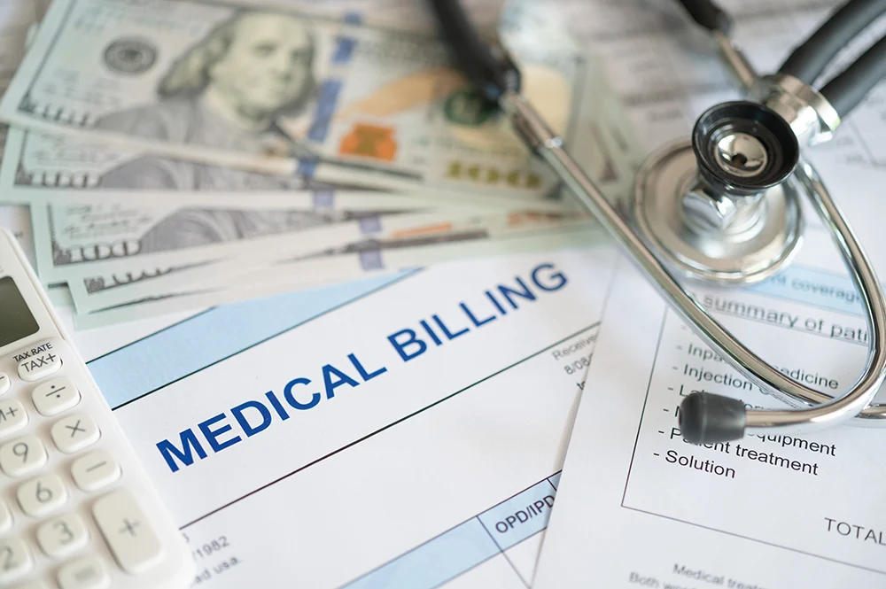 Medical Billing strategy concept with stethoscope on top of hundred dollar bills.