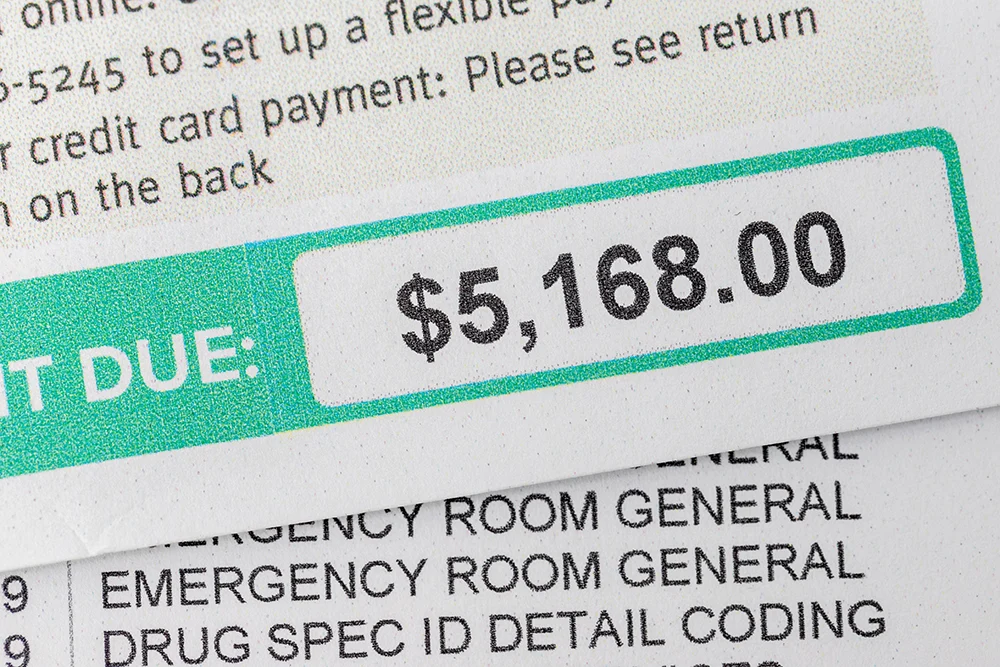 Close-up of a hospital bill showing a large payment due, representing challenges in managing patient balances for emergency and urgent care facilities.